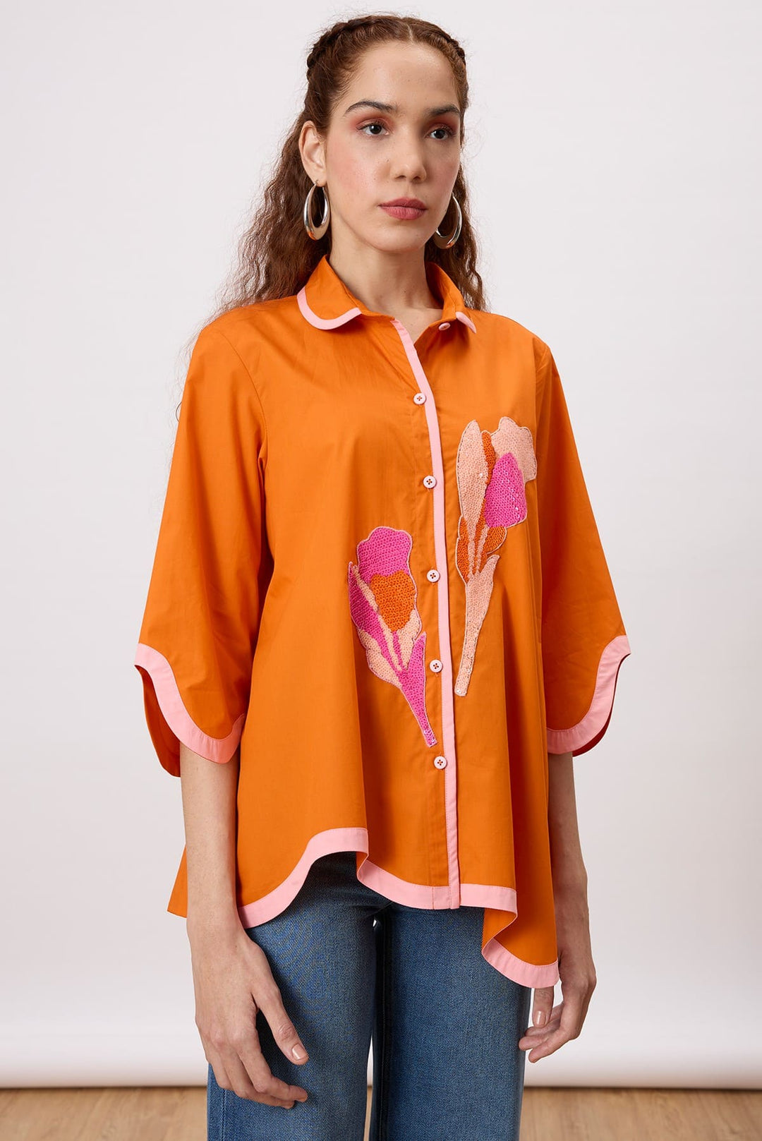 Liam Applique Shirt A charming button-down shirt with a wave shaped hemline and sequin