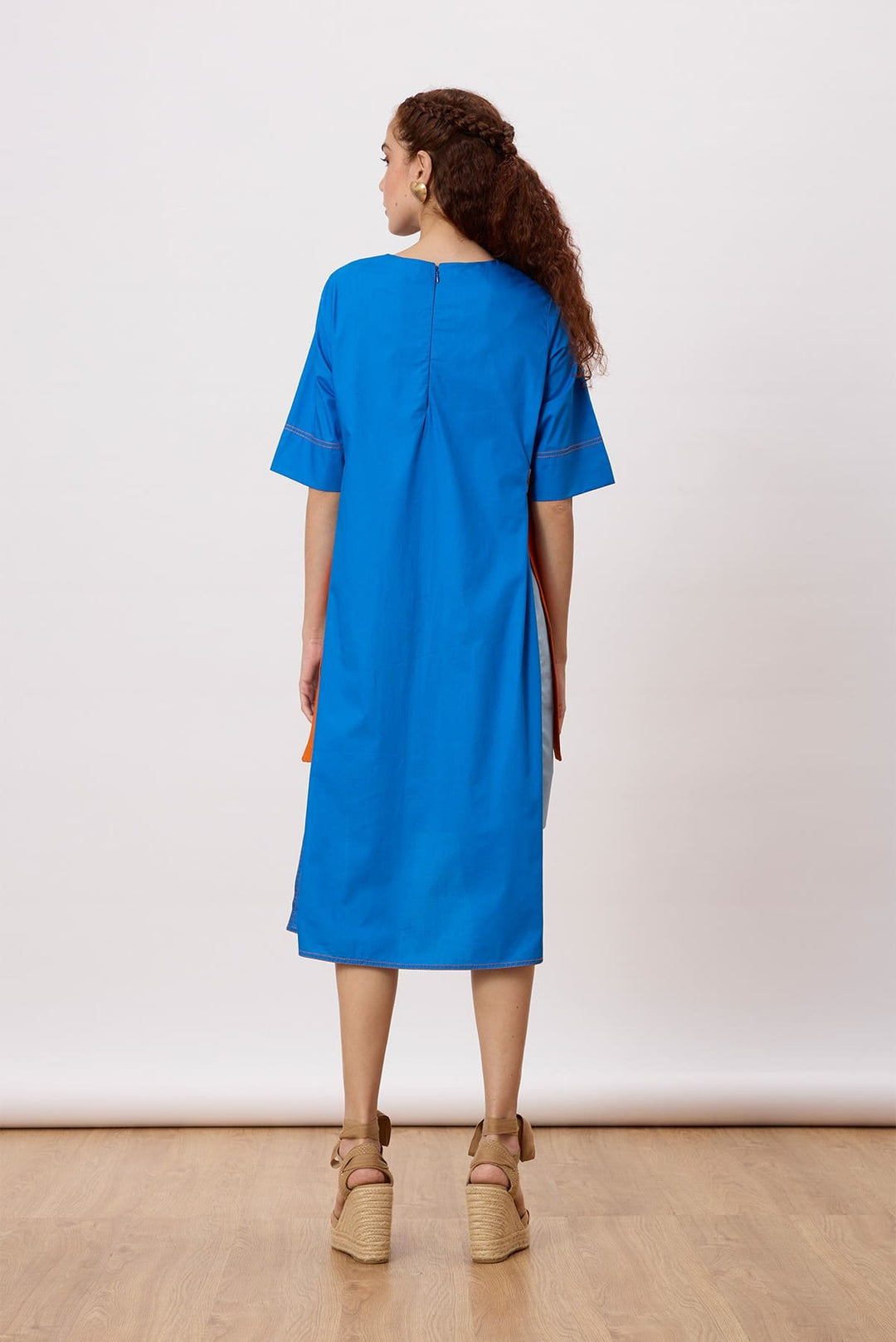 July Dress A relaxed, a-line dress with contrast panels and buckle belt detail at the sides