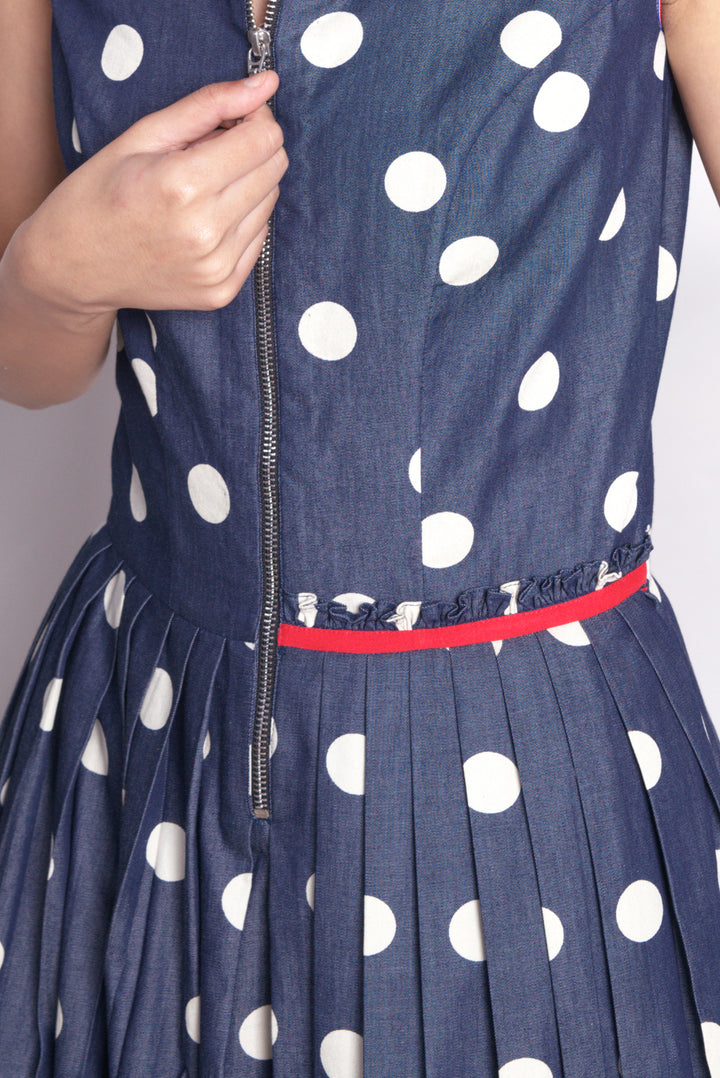 Sleeveless dress in polka dot denim with stand round collar and front  zip opening