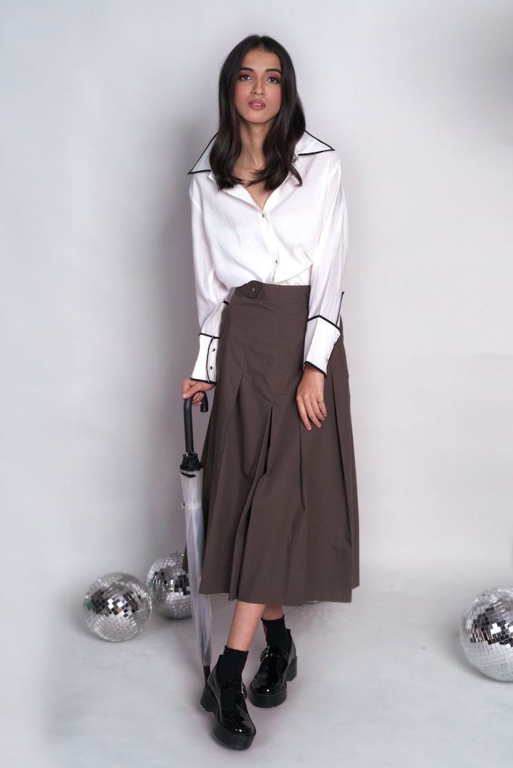 Crisp white shirt with black cord detail along the collar ad cuff